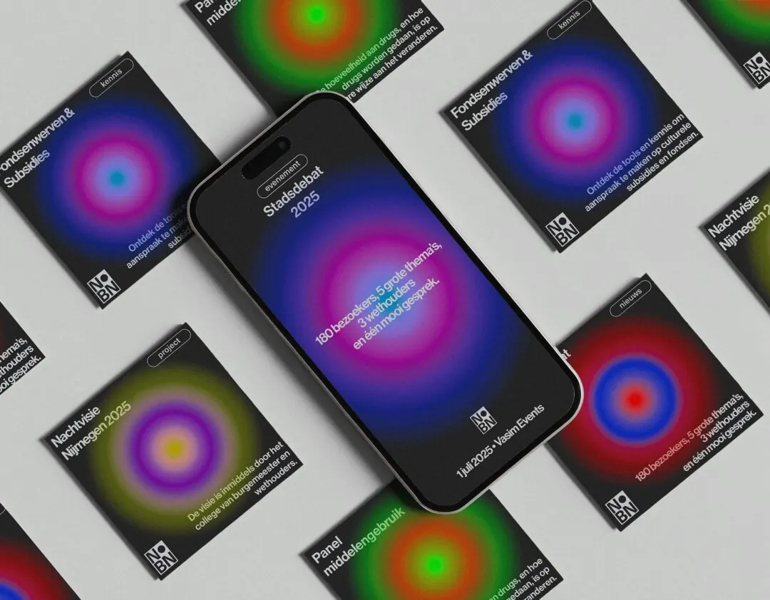 A phone surrounded by printed cards with coloured gradients