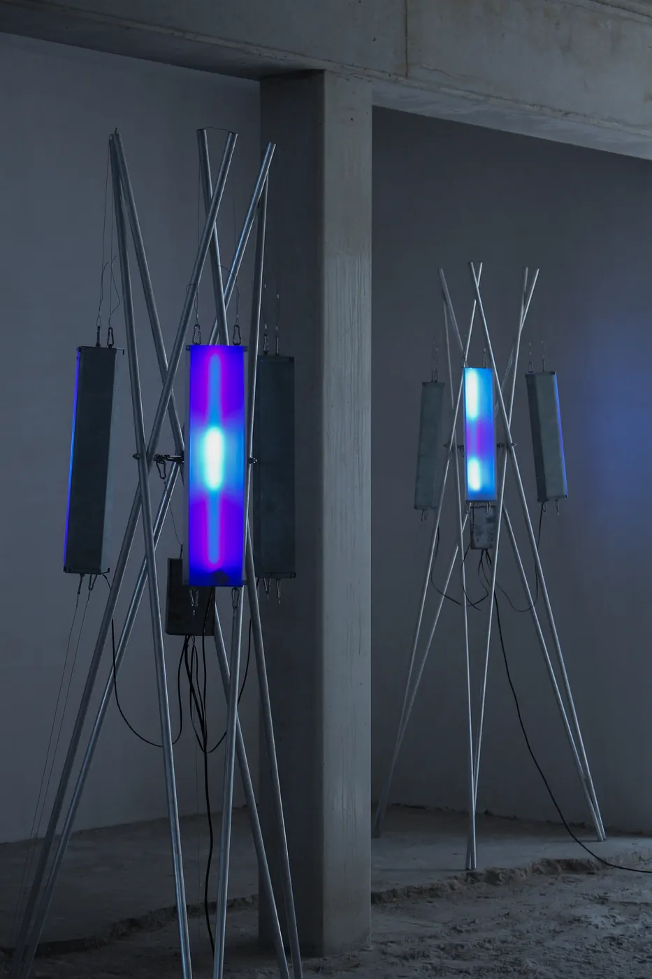 Two antenna sculptures with violet and blue light tubes