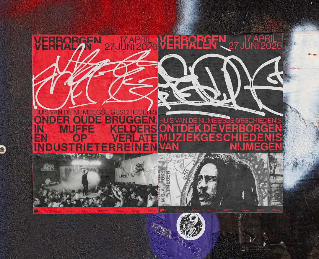 Two red campaign posters pasted on a graffiti covered wall